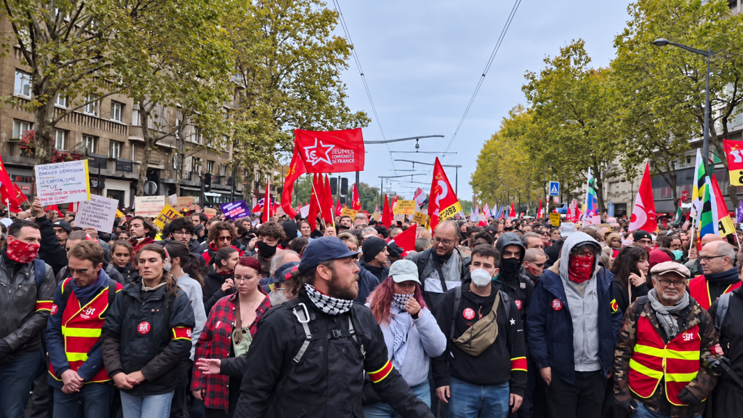 A mass demonstration in France, with red flags of trade unions and political organisations lining the city streets.